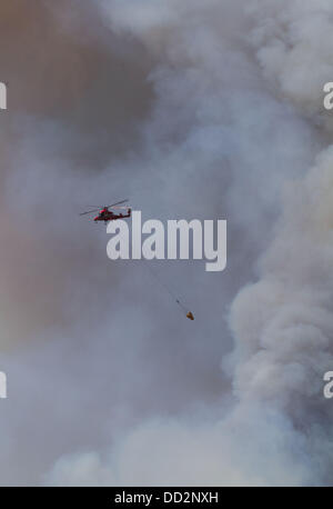 Buck Meadows, CA, USA. 23. August 2013. Einer der mehrere Hubschrauber ist durch die Rauchfahne von Rim Fire in den Schatten gestellt. Rim Fire in der Stanislaus National Forest entlang Highway 120 wächst weiter. Laut dem US Forest Service ab Freitag Aug. 23. 2013 am Nachmittag das Feuer auf 125.620 Hektar mit nur 5 % Containment mit mehr Evakuierungen in Tuolumne City, CA und Umgebung entlang der Autobahn 108 angewachsen ist. In mehrere Richtungen einschließlich Richtung Yosemite National Park breitet sich das Feuer weiter. Bildnachweis: Marty Bicek/ZUMAPRESS.com/Alamy Live-Nachrichten Stockfoto