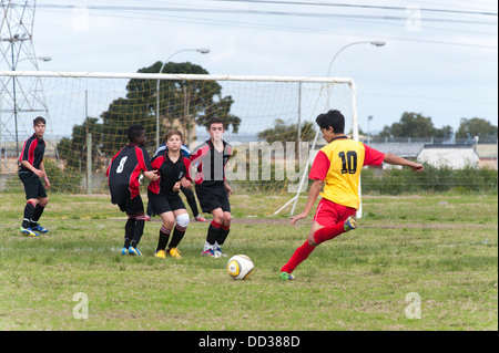 U15B-Football-Spieler tritt einen Freistoß über eine Mauer von Spielern, Cape Town, Südafrika Stockfoto