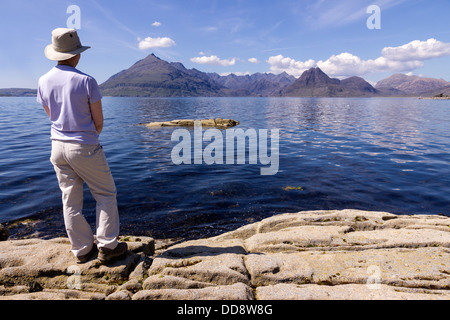 Weiblichen Urlauber genießen Sie Blick von Elgol über Meer Loch Scavaig nach Black Cuillin Berge, Isle Of Skye, Schottland, Großbritannien Stockfoto