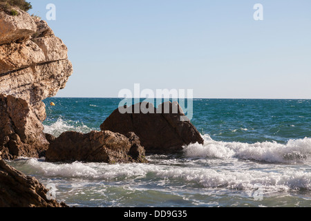 Wellen brechen sich am felsigen Klippen Stockfoto