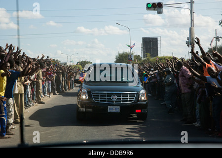 Menschen säumen die Straße, wie uns die Autokolonne von Präsident Barack Obama seinen Weg auf das State House 1. Juli 2013 in Dar Es Salaam, Tansania macht. Stockfoto