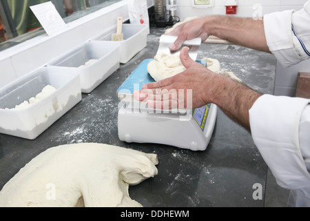 Bäcker wiegt Teig für Brot Stockfoto