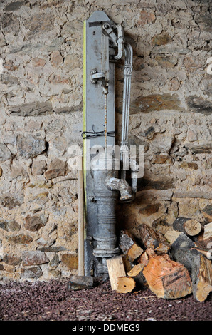 Altfranzösisch Hand Wasserpumpe in einem Stein gebaut Scheune. Stockfoto