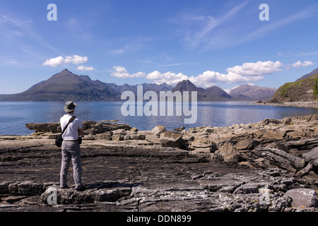 Männliche Urlauber genießen Sie Blick von Elgol über Meer Loch Scavaig nach Black Cuillin Berge, Isle Of Skye, Schottland, Großbritannien Stockfoto