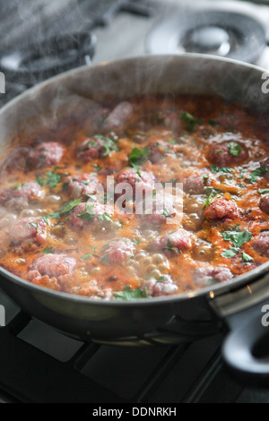 Marokkanische Fleischbällchen in Tomatensauce kochen, die Frikadellen in einem Topf kochen Stockfoto