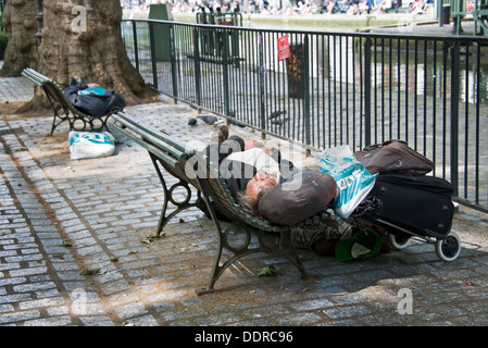 Obdachloser schlafen auf einer Bank - Canal St-Martin, Paris, Frankreich Stockfoto