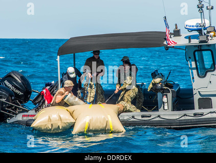 Mitglieder des Explosive Ordnance Entsorgung Mobile Einheit (EODMU) 5, zusammen mit Great Barrier Reef Marine Park Authority Berater Michael Phelan, arbeiten zusammen, um ausgemustertem Kampfmittel aus dem Great Barrier Reef Marine Park erholen. Germantown ist Bestandteil der Stockfoto