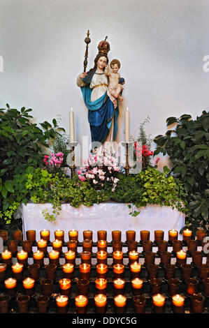 Aufopfernde Kerzen und eine Statue der Maria trägt eine Krone Holding Jesuskind, Schaeftlarn Abbey, Schäftlarn, Bayern Stockfoto