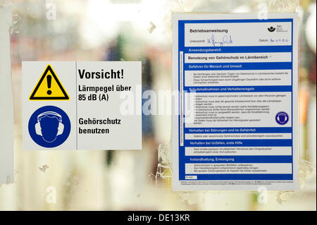 Zeichen in Deutsch, Vorsicht Lärmpegel über 85 dB, Gehörschutz, Richtlinien für die Verwendung von Gehörschutz in Stockfoto