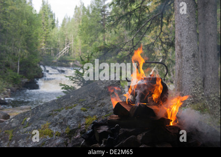 Wasser wird gekocht, in der Wildnis, Kaffee-Wasserkocher auf dem offenen Feuer, Flammen und Rauch, Fulvan Fluss, Tjaernvallen in der Nähe der Stockfoto