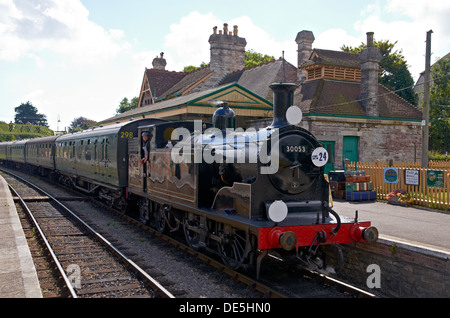 Dampfzug auf stehenden Swanage Bahn Haltestelle Corfe Castle, Dorset, England - Ansicht der 1950er Jahre erinnert. Stockfoto