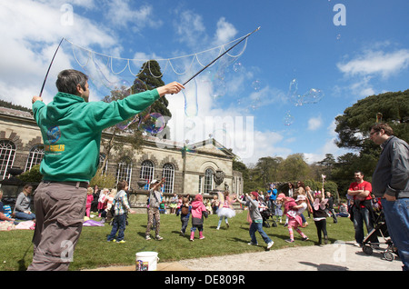 Man Luftblasen machen unterhaltsame Kindern in Margam Park, South Wales UK. Stockfoto