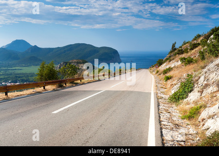 Bergstraße mit blauen bewölkten Himmel und Meer auf einem Hintergrund. Adria, Montenegro Stockfoto