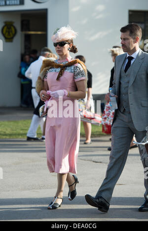 Chichester, West Sussex, UK. 14. September 2013. Beim Goodwood Revival. Goodwood-Rennstrecke, West Sussex - Samstag, den 14. September. Ein Besucher kommt gekleideten in zeitgenössischer Kleidung. Bildnachweis: MeonStock/Alamy Live-Nachrichten Stockfoto