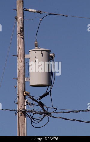 Hydro Transformator auf Bauernhof auf der Pole mit vielen Kabeln. Stockfoto