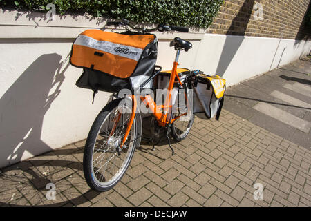 London, UK. 16. September 2013. Die Royal Mail-Flotation droht ebenso wie TNT Studien eine eigene Tür zu Tür service im Süden von London. Dies hat dazu geführt, das Erscheinungsbild der Briefträger mit markanten orangefarbenen Fahrräder der Marke TNT. Diese sind geworden ein Kuriosum und eine Bedrohung für die traditionelle Briefträger, die sind "verwirrt", dass sie unbeaufsichtigt, entriegelt und offen für Diebstahl auf Wohnstraßen, während immer noch anscheinend voll gelassen werden der Post. Bildnachweis: Guy Bell/Alamy Live-Nachrichten Stockfoto