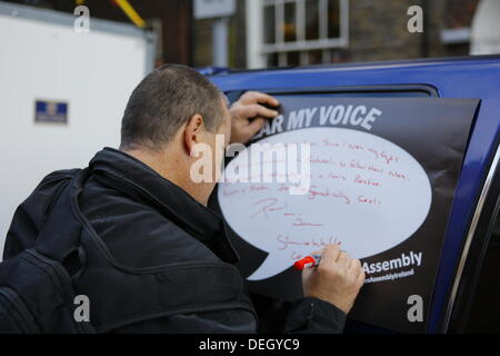 Dublin, Irland. 18. September 2013. Ein Demonstrant schreibt seine eigenen Zeichen des Protests. Demonstranten halten eine Volksversammlung außerhalb der Dail (Irisches Parlament), um Sparmaßnahmen in kleineren Gruppen zu diskutieren. Die Versammlung war Teil eines Tages der Proteste mit der Rückkehr der TDS (Mitglieder des Parlaments) aus ihrer Sommerpause zusammenfallen. Bildnachweis: Michael Debets/Alamy Live-Nachrichten Stockfoto