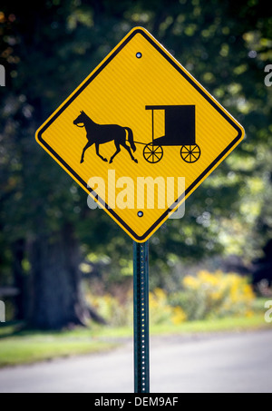 Eine gelbe Verkehr Schild Warnung Fahrer dort sind amische Buggys voraus. Stockfoto