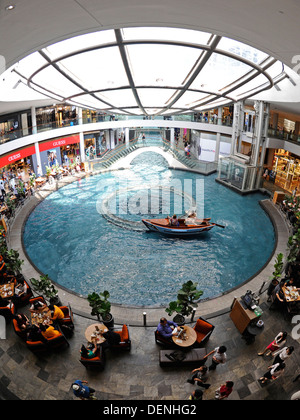 Shopper mit einem Boot fahren Sie in einer Gondel auf die Shoppes at Marina Bay Sands Einkaufszentrum in Singapur. Stockfoto