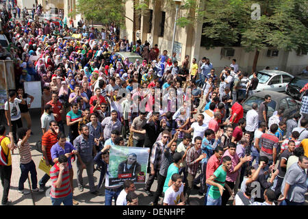 Kairo, Ägypten. 22. September 2013. Ägyptische Studenten der Universität Kairo offene Handflächen mit vier erhobenen Finger, gewordene Symbol der Rabaah al-Adawiya Moschee, wo Mursi-Anhänger ein Sit-in wochenlang gehalten hatte, die heftig im August, während einer Protestaktion am ersten Tag des neuen akademischen Jahres, bei der Unterstützung des Ägyptens gestürzten islamistischen Präsidenten Mohamed Morsi, in Kairo am 22. September verteilt wurde , 2013 Credit: Ahmed Asad/APA Images/ZUMAPRESS.com/Alamy Live-Nachrichten Stockfoto