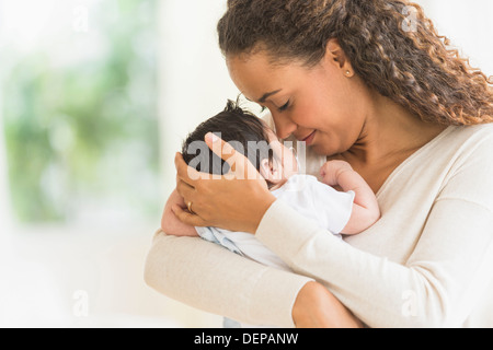 Hispanische Mutter Holding Säuglingssohn Stockfoto