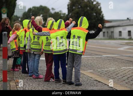 Erstklässler der Grundschule "Am Elbdamm" tragen Warnwesten mit dem Schriftzug "Traffic-Detektive" in Magdeburg, Deutschland, 23. September 2013. Die Sicherheitswesten können helfen, die Schüler im Verkehr mehr sichtbar sein. Startschuss für die Übergabe von der Westen ein Verkehrs-Sicherheit-Kampagne des deutschen Automobilclub ADAC unter der Schirmherrschaft von Sachsen Anhalts Minister für Unterricht und Kunst in seiner Funktion als Vorsitzender der Konferenz der deutschen Kultusminister und Kunst. Foto: Jens Wolf Stockfoto