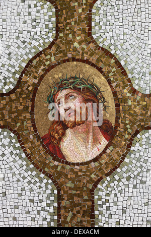 Ein Mosaik zeigt den gekreuzigten Jesus mit der Dornenkrone. Anwendung auf einem Grabstein auf dem Friedhof von Spilimbergo, Italien. Stockfoto