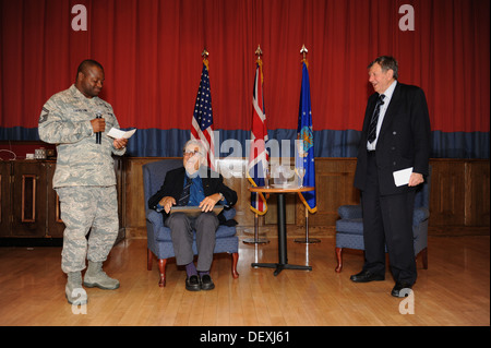 US Air Force Senior Master Sergeant Cornelius Thompson, links, 100. Operations Support Squadron Flugplatz Manager, ehemaliger Royal Air Force Cdre präsentiert. Charles Clarke, Recht, ein ehemaliger Kriegsgefangener, mit einem Geschenk in der Gefangenen-von-Krieg/Missing-In-Actio Stockfoto