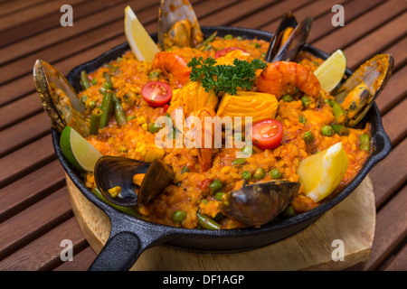 mediterranen Paella mit Meeresfrüchten in Pfanne auf Holzbrett Stockfoto