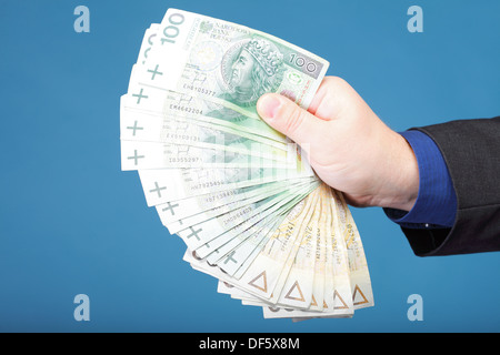 Das Unternehmer Hand mit Polnisch Geld Banknote blau Hintergrund Stockfoto