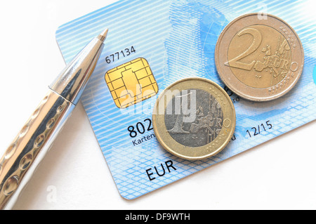 Euro-Münzen und Stift auf eine Kreditkarte Stockfoto