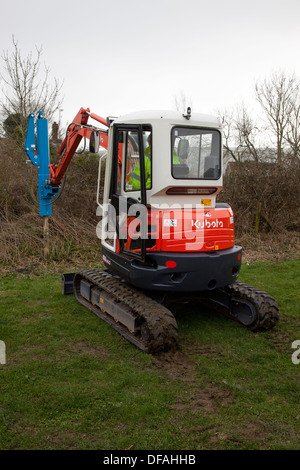 Ein Kubota mit einem Post Stanzen attachment UK Stockfoto