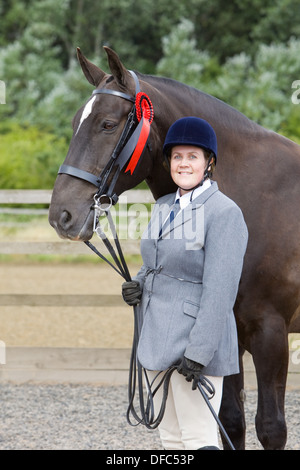 Ein Konkurrent mit ihrem Pferd an einem Outdoor-Reitwettbewerb Stockfoto