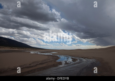 Das Wasser des Medano Creek fließt kurz über eine sandige waschen vor dem verschwinden, Great Sand Dunes National Park, Colorado. Stockfoto