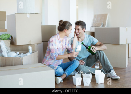 Paar Champagner trinken und Essen chinesisches Essen Erdgeschoss im neuen Haus Stockfoto