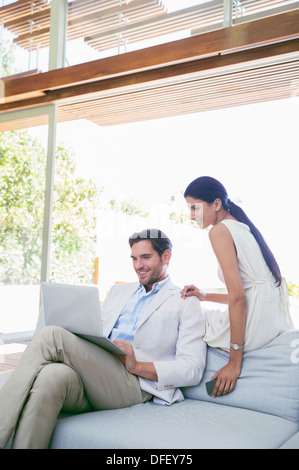 Paar mit Laptop auf sofa Stockfoto