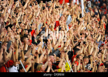 Fans der deutschen Fußball-Bundesligisten Bayer 04 Leverkusen erheben ihre Hände im support Stockfoto