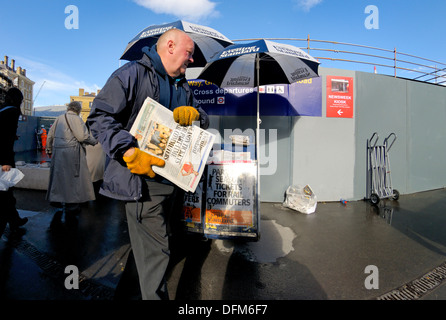 London, England, Vereinigtes Königreich. Zeitung-Verkäufer vor der Kings Cross station Stockfoto