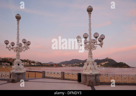 Straßenlaternen am Meer promenade in der Abenddämmerung, Bahia De La Concha, San Sebastian, Playa De La Concha, Donostia, Camino De La Cos Stockfoto