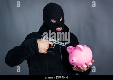 Mann mit Gewehr auf Ping-Sparschwein Stockfoto