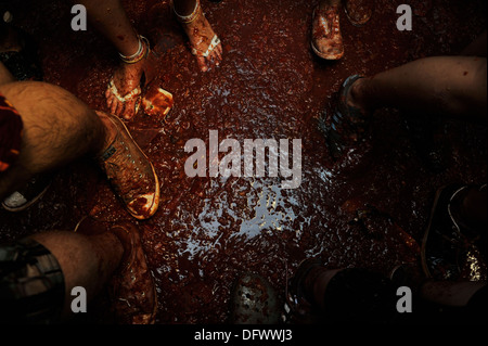 Bunol, Valencia, Spanien - Teilnehmer des jährlichen "Tomatina" waten durch Tomatenmark Stockfoto