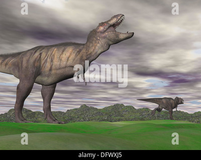 Aggressiven Tyrannosaurus Rex Dinosaurier Knurren bei einem anderen T-Rex, der Weg in eine grüne Berglandschaft ausgeführt wird. Stockfoto