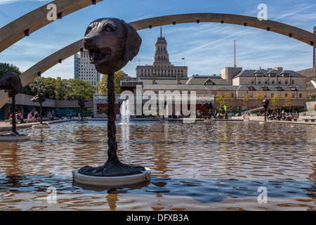 Menschen sitzen auf Bänken rund um den Teich mit Springbrunnen, Bögen und MASTSCHALTTAFEL Skulpturen in Nathan Phillips Square, Toronto Stockfoto