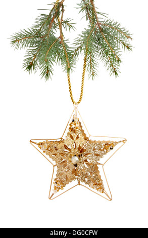 Gold-Glitter und jeweled Weihnachtsstern aus dem Zweig von einem Weihnachtsbaum hängen Stockfoto