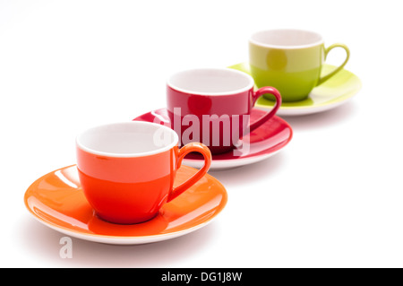 Drei farbige Espresso-Tassen in einer Reihe mit weißem Hintergrund Stockfoto