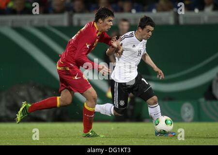 Wiesbaden, Deutschland. 11. Oktober 2013. Deutschlands Amin Younes (R) wetteifert um den Ball mit Montenegros Marko Bakic während der U21 Europäische Springerinnen Qualifier Spiel zwischen Deutschland und Montenegro in der BRITA-Arena in Wiesbaden, Deutschland, 11. Oktober 2013. Foto: Fredrik von Erichsen/Dpa/Alamy Live News Stockfoto