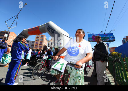 El Alto, Bolivien. 12. Oktober 2013.  Wettbewerber Line-up vor dem Start von einem Cholitas Radrennen für indigene Aymara Frauen. Das Rennen findet auf einer Höhe von etwas mehr als 4.000 m entlang der Hauptstraßen in der Stadt El Alto (oberhalb der Hauptstadt La Paz) für bolivianische Womens Tag wurde gestern Freitag, den 11. Oktober statt. Bildnachweis: James Brunker / Alamy Live News Stockfoto
