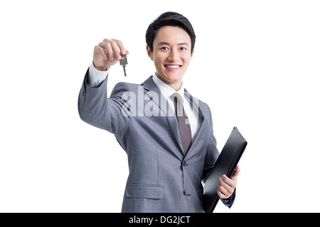 Junger Geschäftsmann mit einem Schlüssel Stockfoto