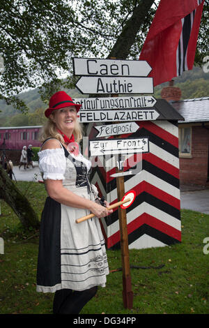 Levisham, Pickering, North Yorkshire, Großbritannien. Oktober 2013. Komische Schilder mit Tricia Fleming aus Retford bei der Veranstaltung ‘Railway in Wartime’ North Yorks Moors Railway (NYMR) am Wochenende 12.-13. Oktober 2013 am Bahnhof Levisham bei schlechtem Wetter hervorgehoben. Levisham Station, wurde während des (NYMR) ‘Kriegswochenendes’ mit antiken Plakaten und französischen Schildern geschmückt, um ‘Le Visham’ in Nordfrankreich zu werden. The Gathering, eine Nachbildung eines französischen Dorfes, das von deutschen Truppen besetzt wurde und Teil der ‘Allo Allo’-artigen, unbeschwerten und lustigen Stimmung war. Stockfoto