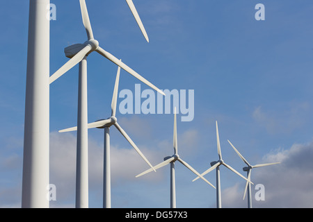 Gruppe von Windmühlen für erneuerbare elektrische Energieerzeugung auf blauen Himmel Stockfoto